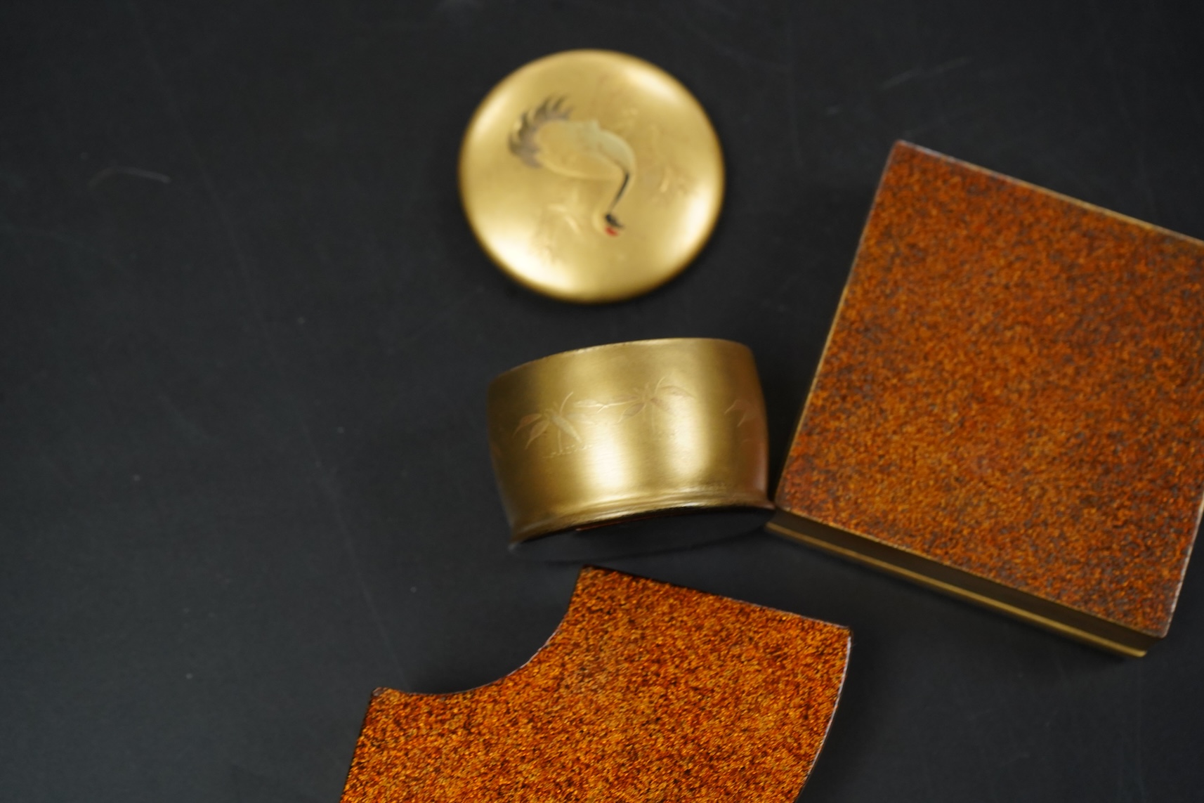 Three Japanese gilt lacquer boxes, one depicting Mount Fuji, largest 9cm wide